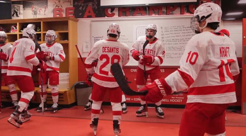 Some players are engaged in discussions, while others are gearing up, adjusting their equipment. 